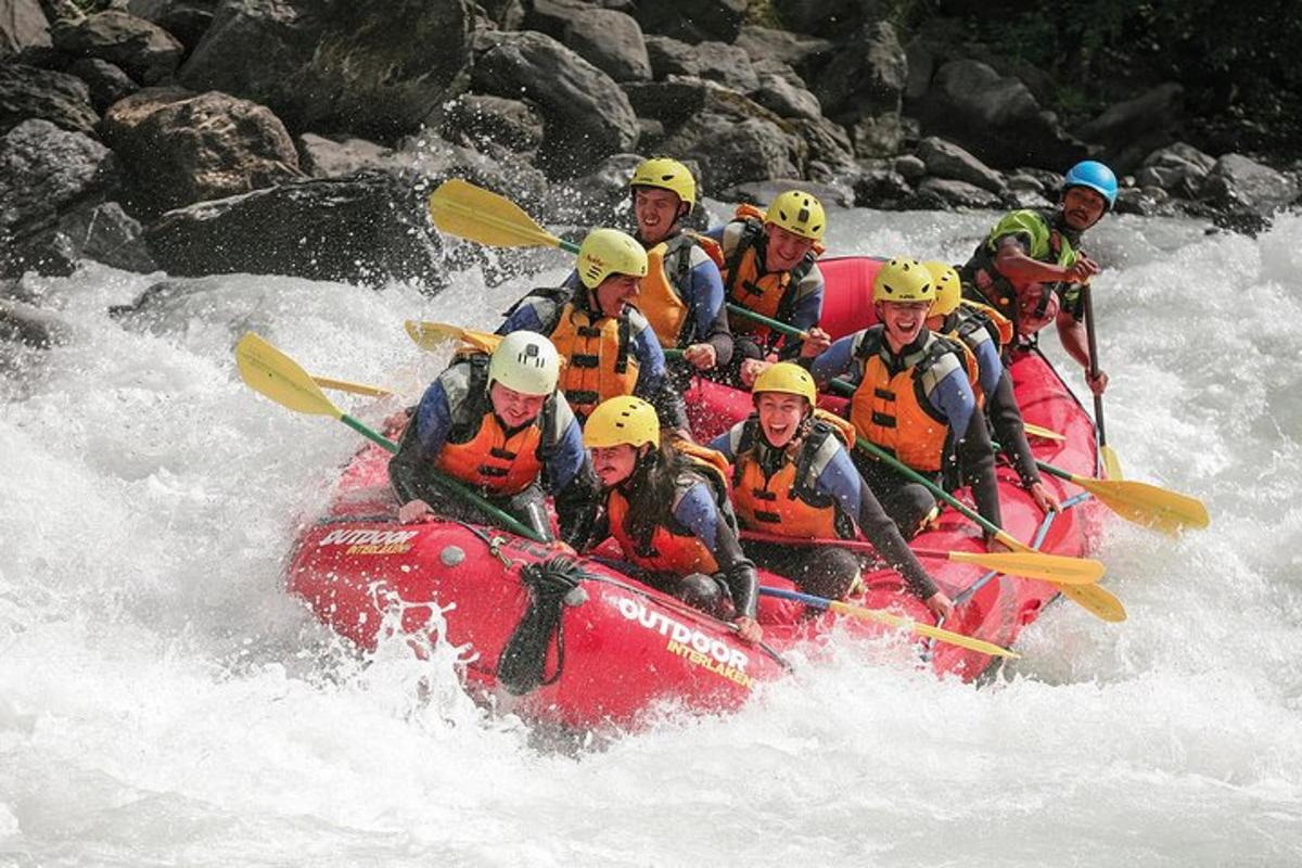 a group of people in a raft in the water