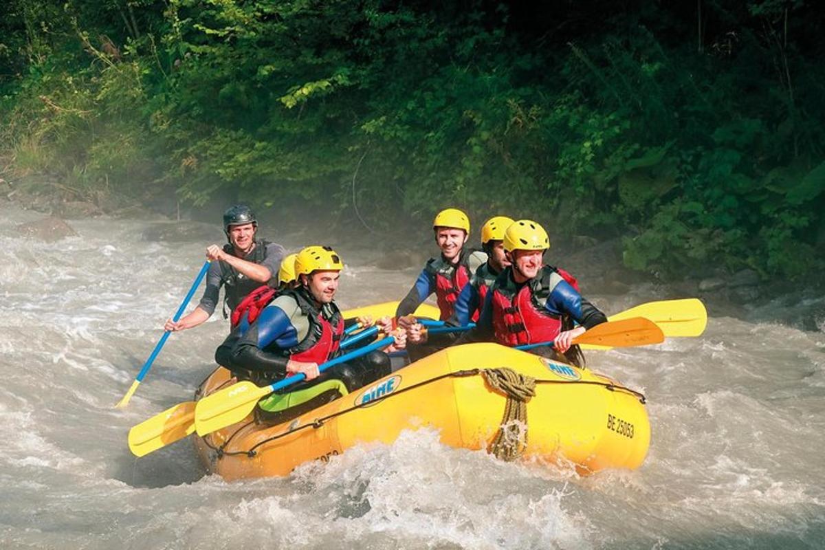 a group of people in a raft in the water