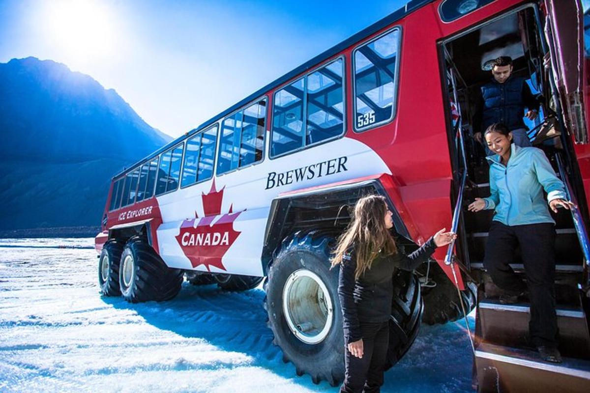 a man and a woman standing next to a double decker bus