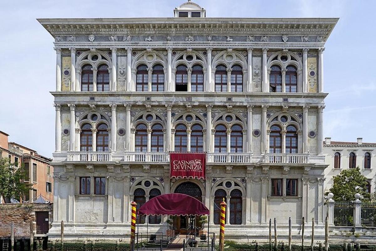 a large white building with a red sign in front of it