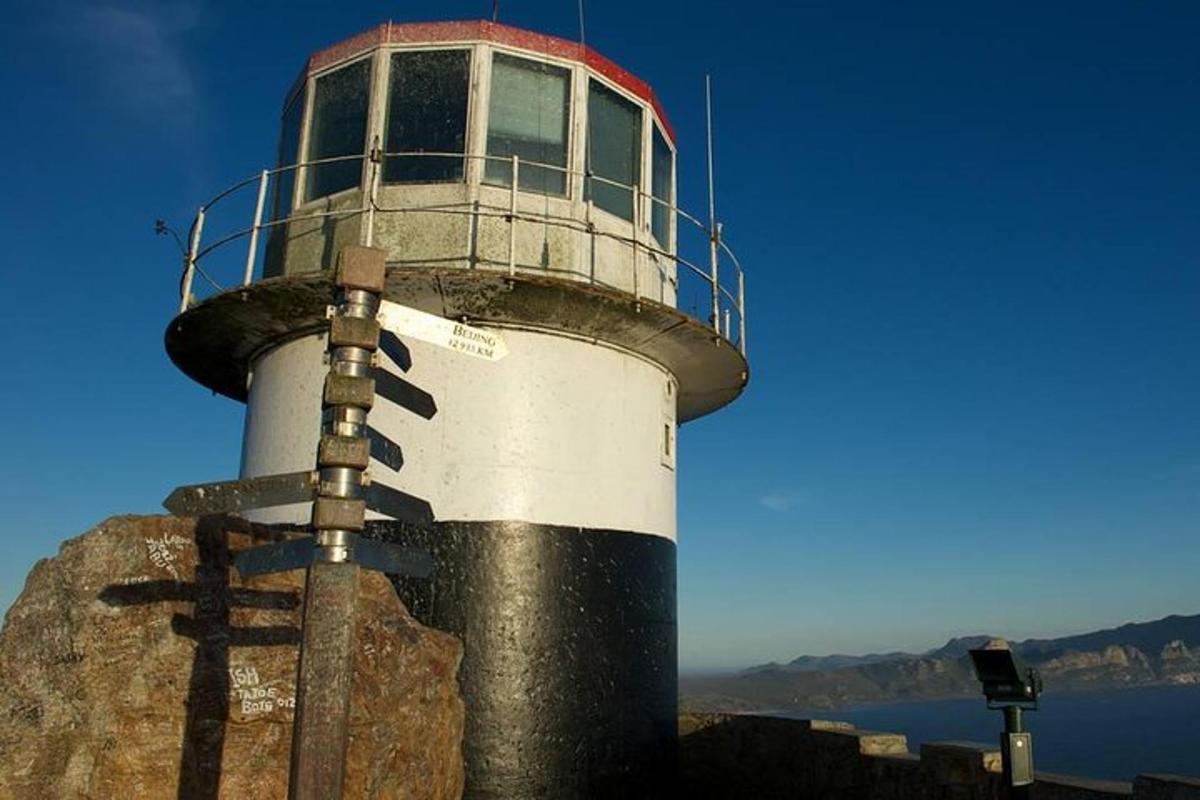 a lighthouse sitting on top of a rock