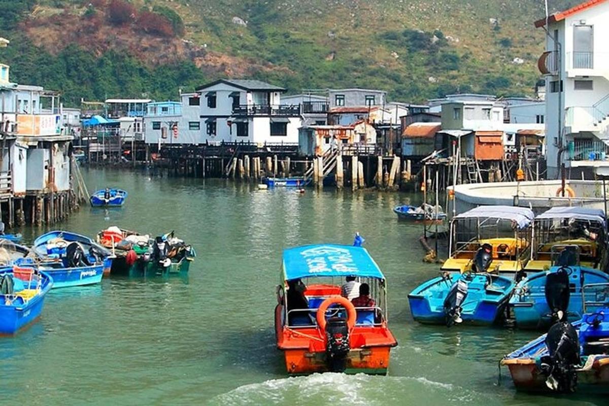 a group of boats in a body of water with houses