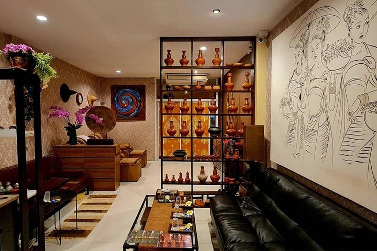 a living room with a couch and a shelf of vases