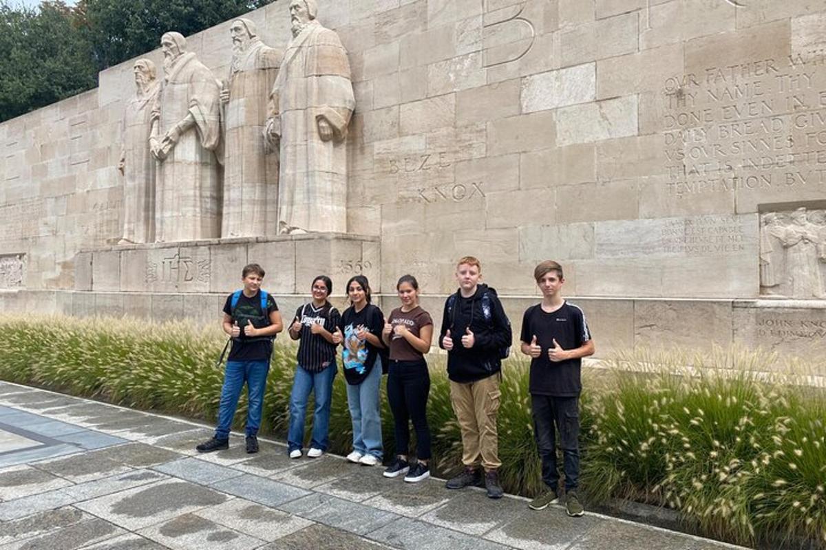 a group of people standing in front of a statue