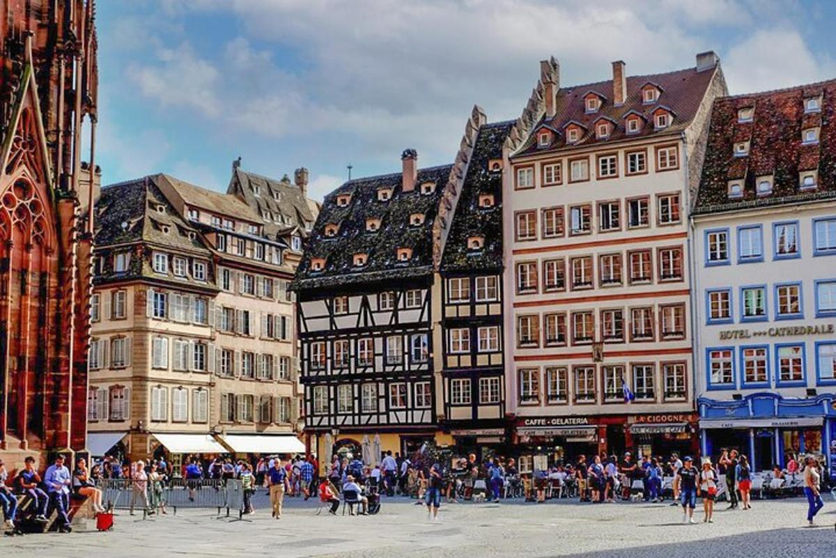a group of people walking around a city with buildings