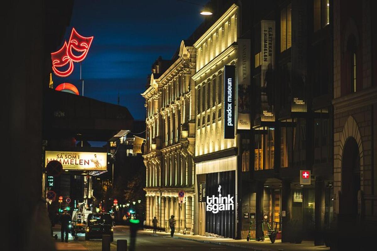a lit up city street at night with buildings