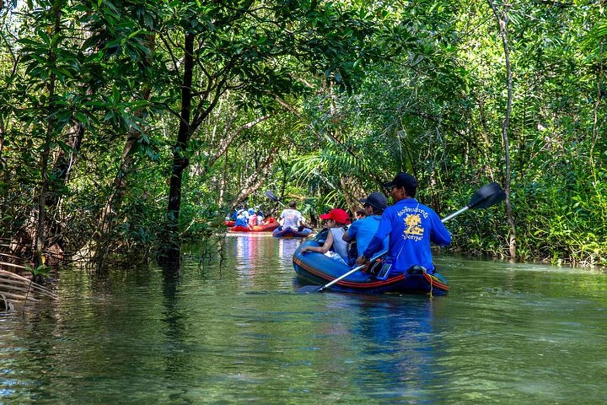 a group of people kayaking down a river