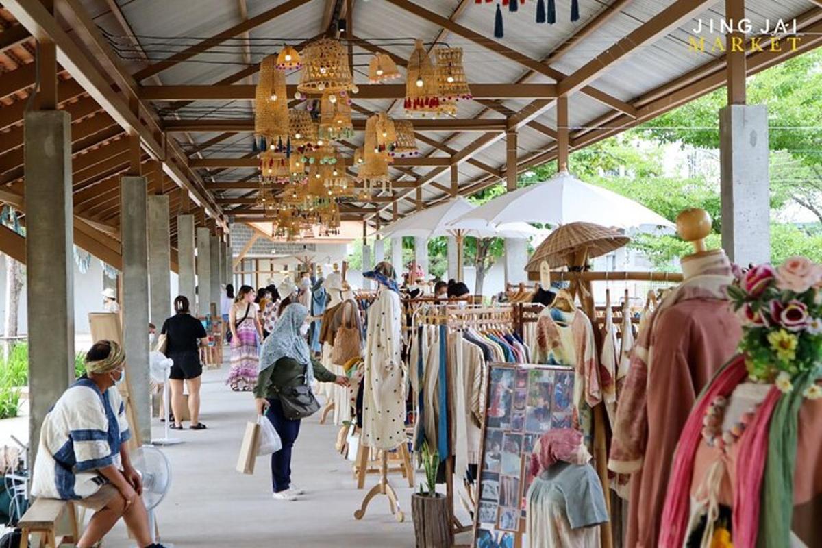 a market with people walking past a clothing store