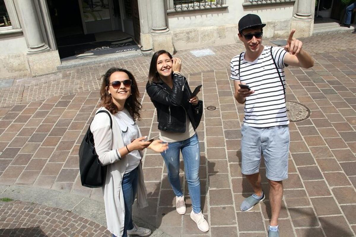 due donne e un uomo posano per una foto con i loro cellulari