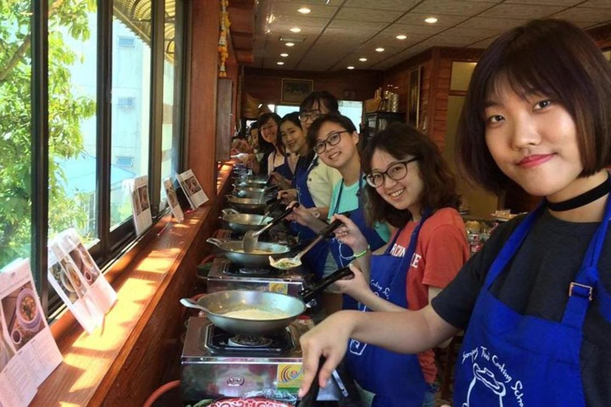 a group of people preparing food at a buffet