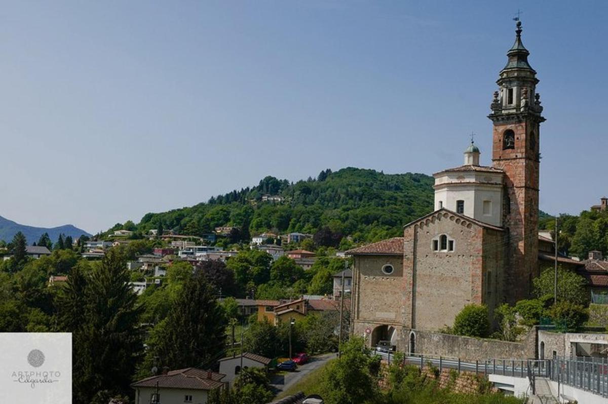 an old building with a clock tower on a hill
