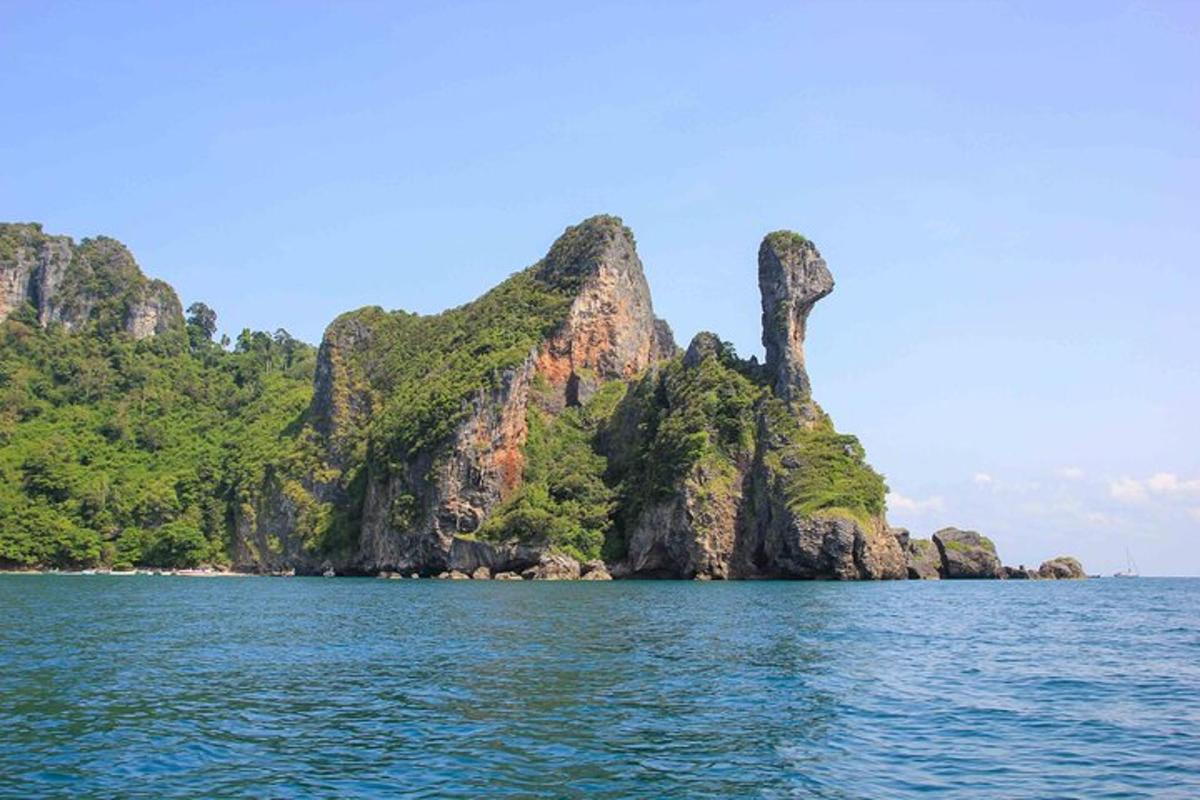 a small island in the water with a mountain