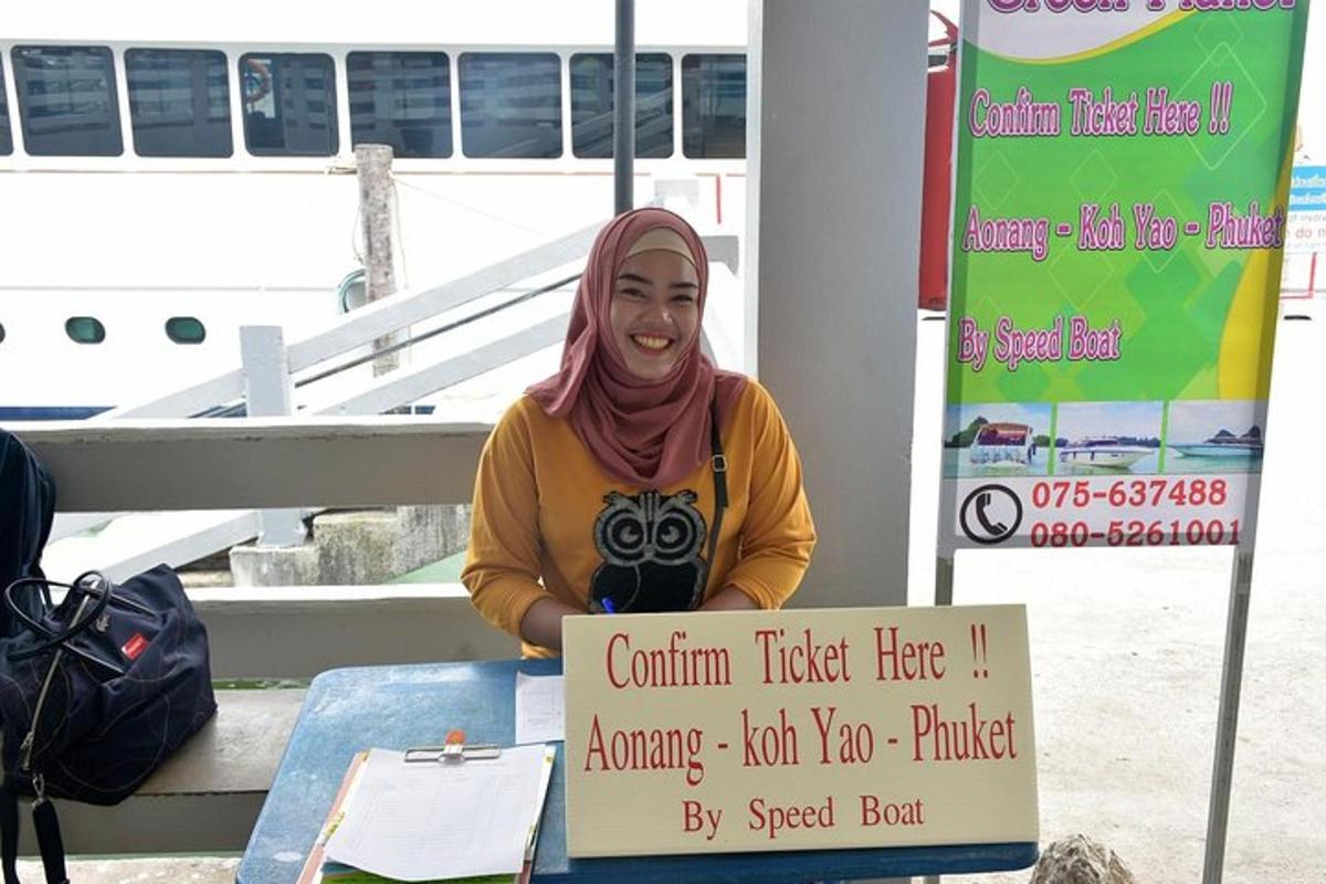 a woman sitting at a table with a sign