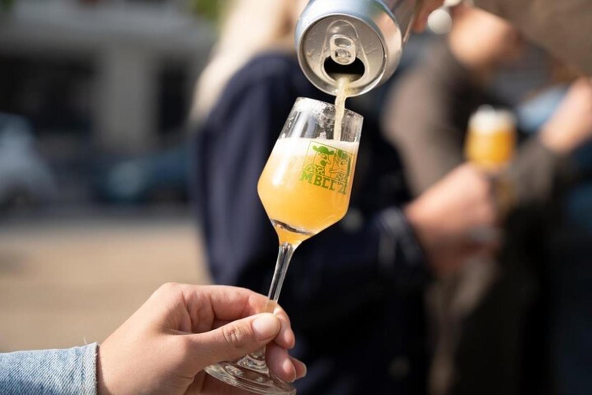 a person is pouring a drink into a wine glass