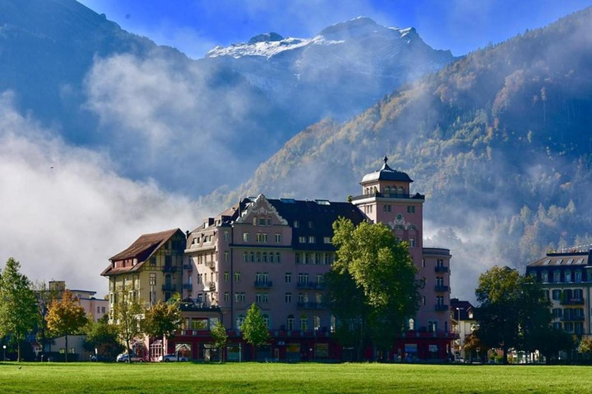 a large building with a mountain in the background