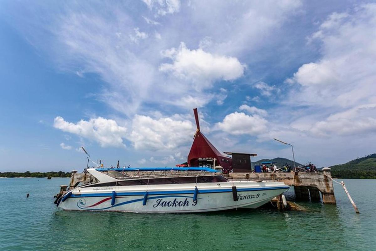 a boat sitting on the water next to a dock