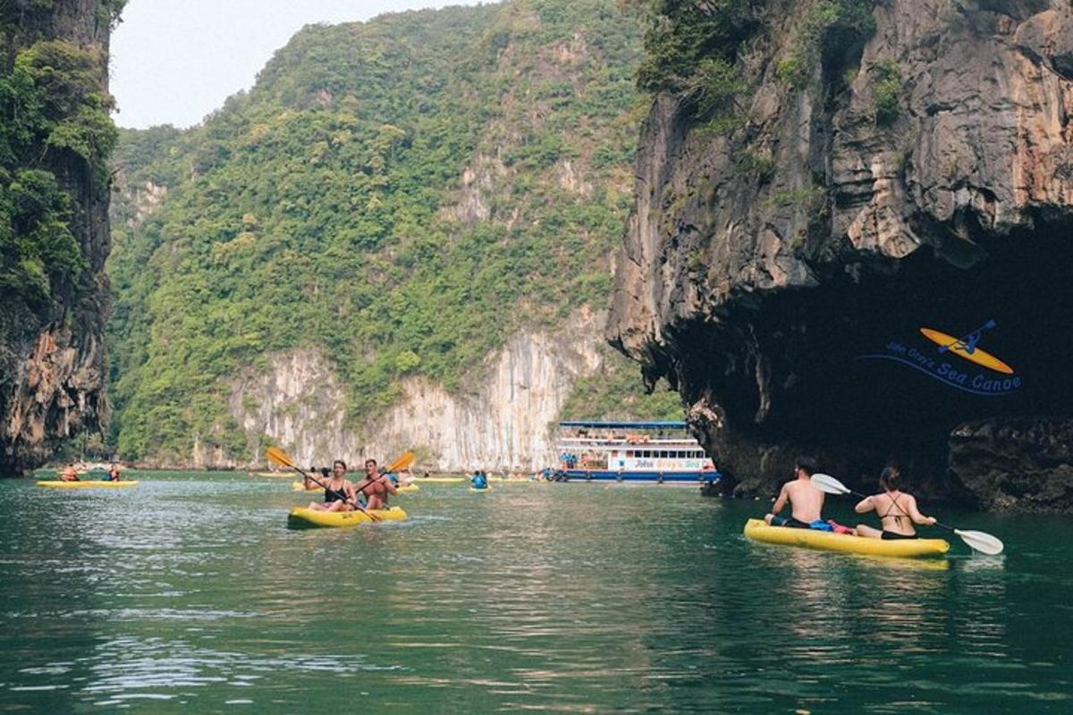 a group of people kayaking in the water in a cave