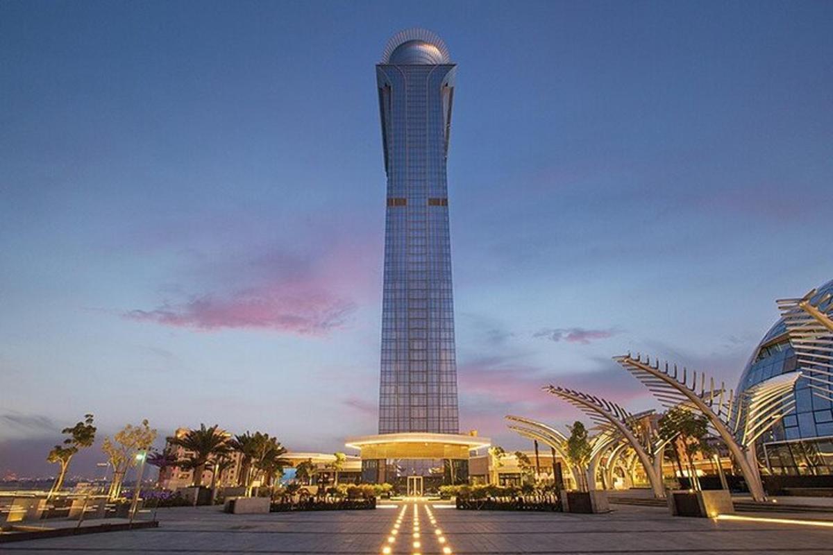 a tall tower in a city with a building