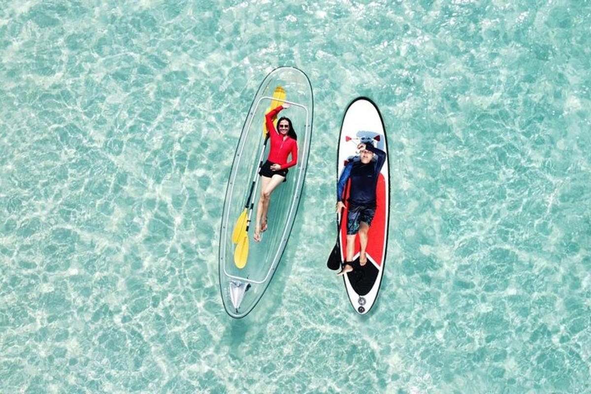 two people in a surfboard in the water