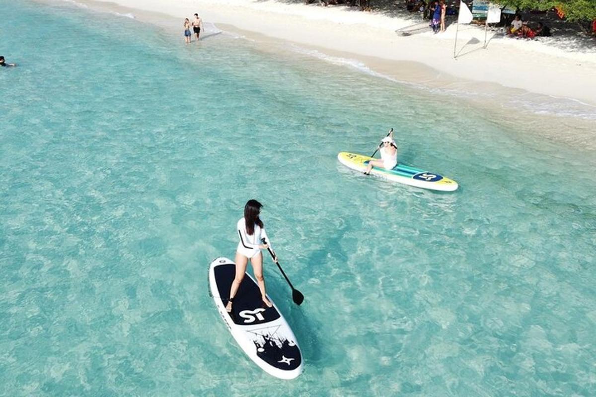 two people are on surfboards in the ocean