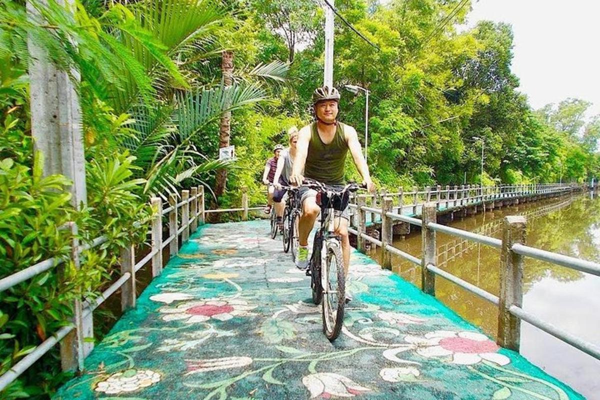 a man riding a bike on a path next to a river