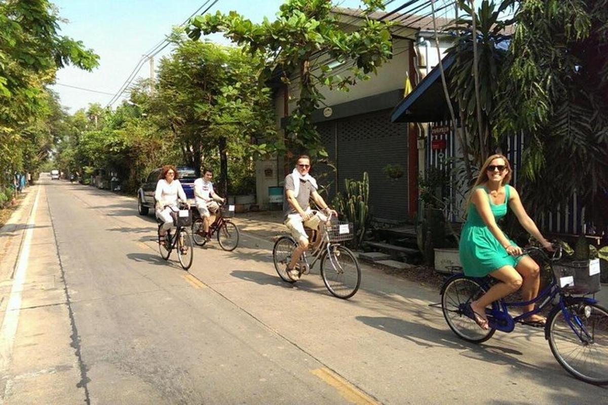 a group of people riding bikes down a street