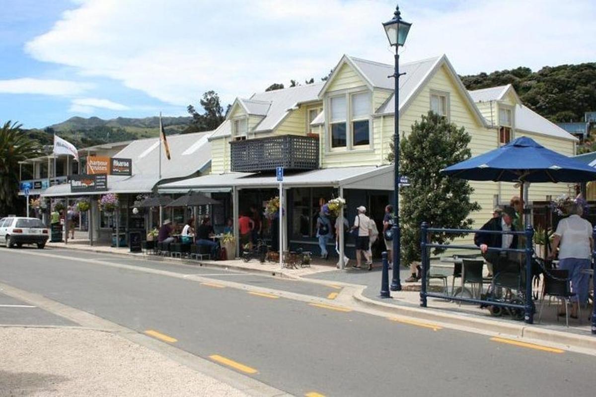 a street with people sitting outside of a building
