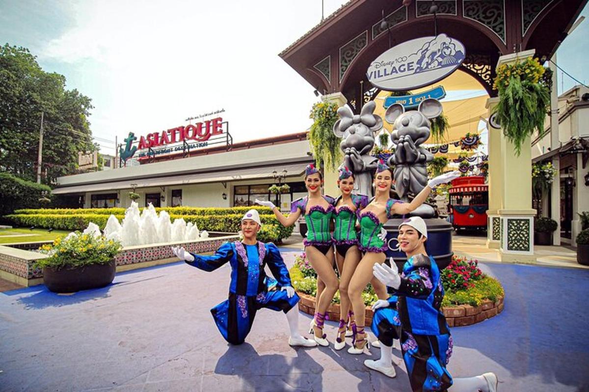 a group of girls in costumes standing in front of a fountain