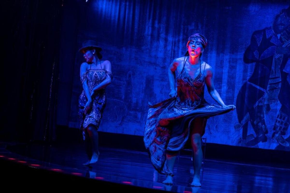two women are performing on a stage