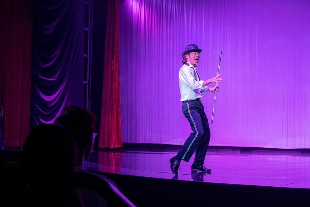 a man standing on a stage giving a presentation
