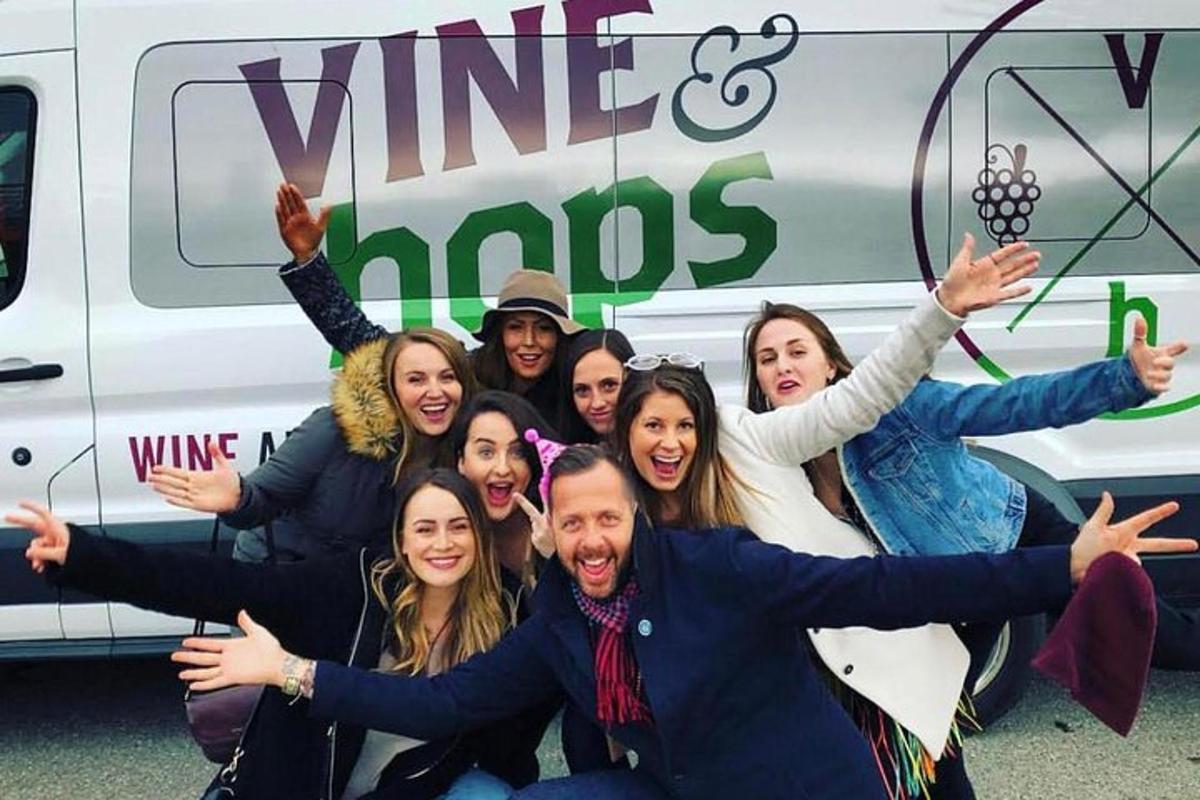 a group of people posing in front of a van