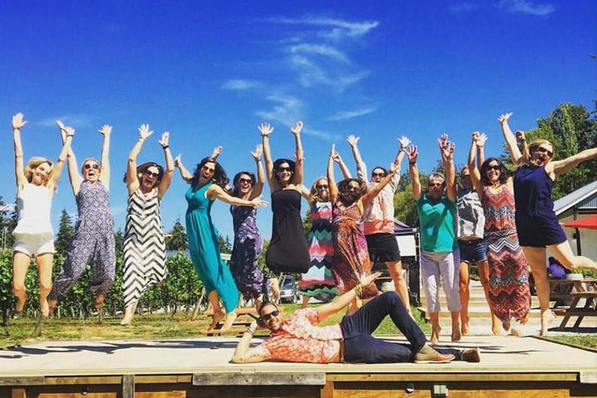 a group of people jumping in the air with their hands in the air