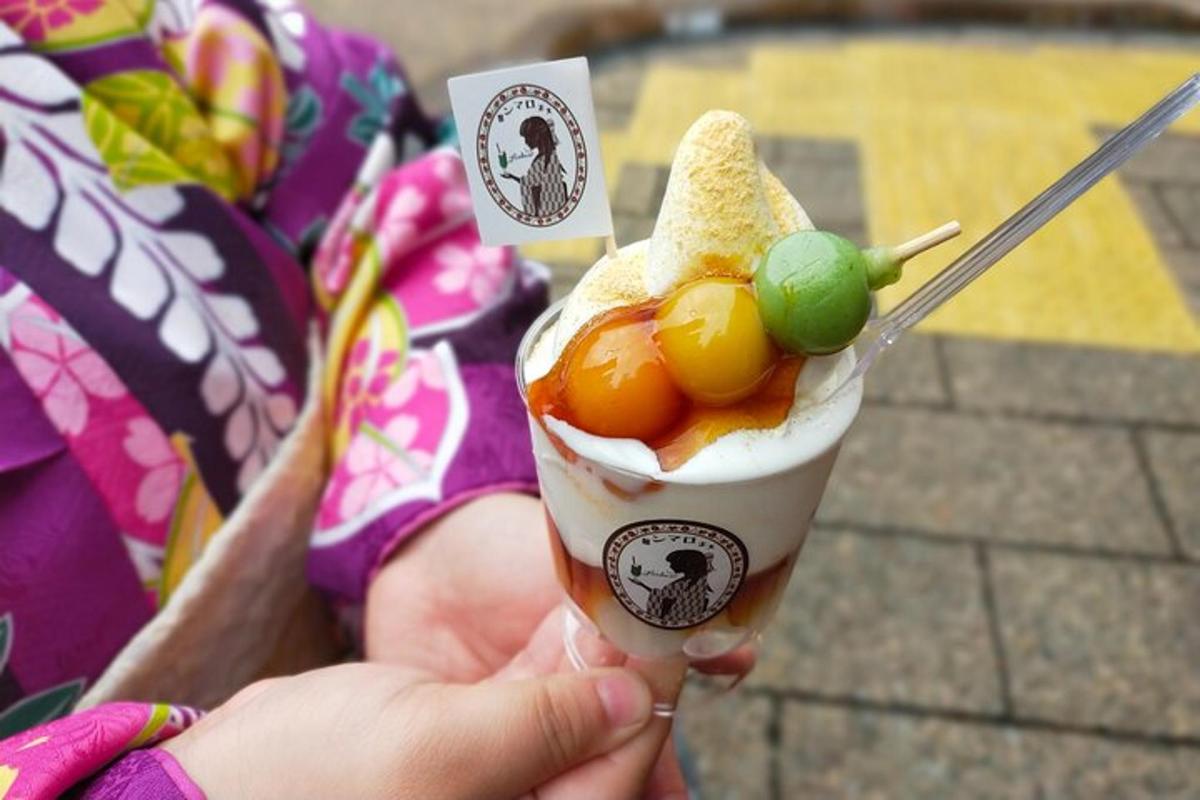 Una persona que sostiene una bebida en un cono con una fruta.