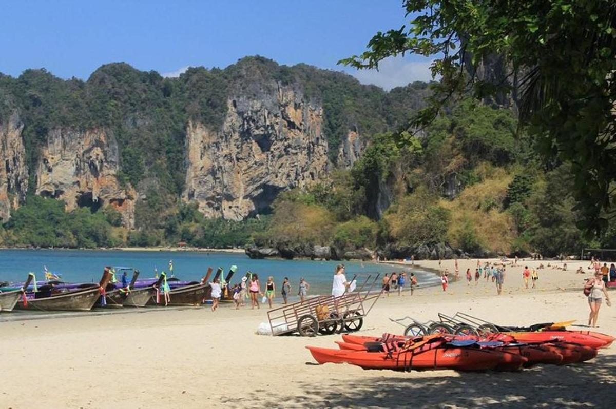 a beach with a group of people and boats on it