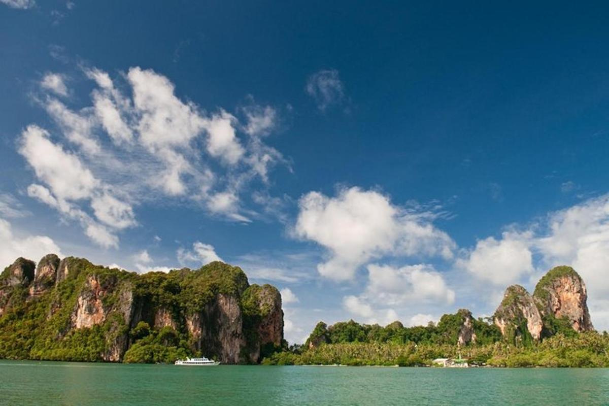 a boat in the water in front of a mountain