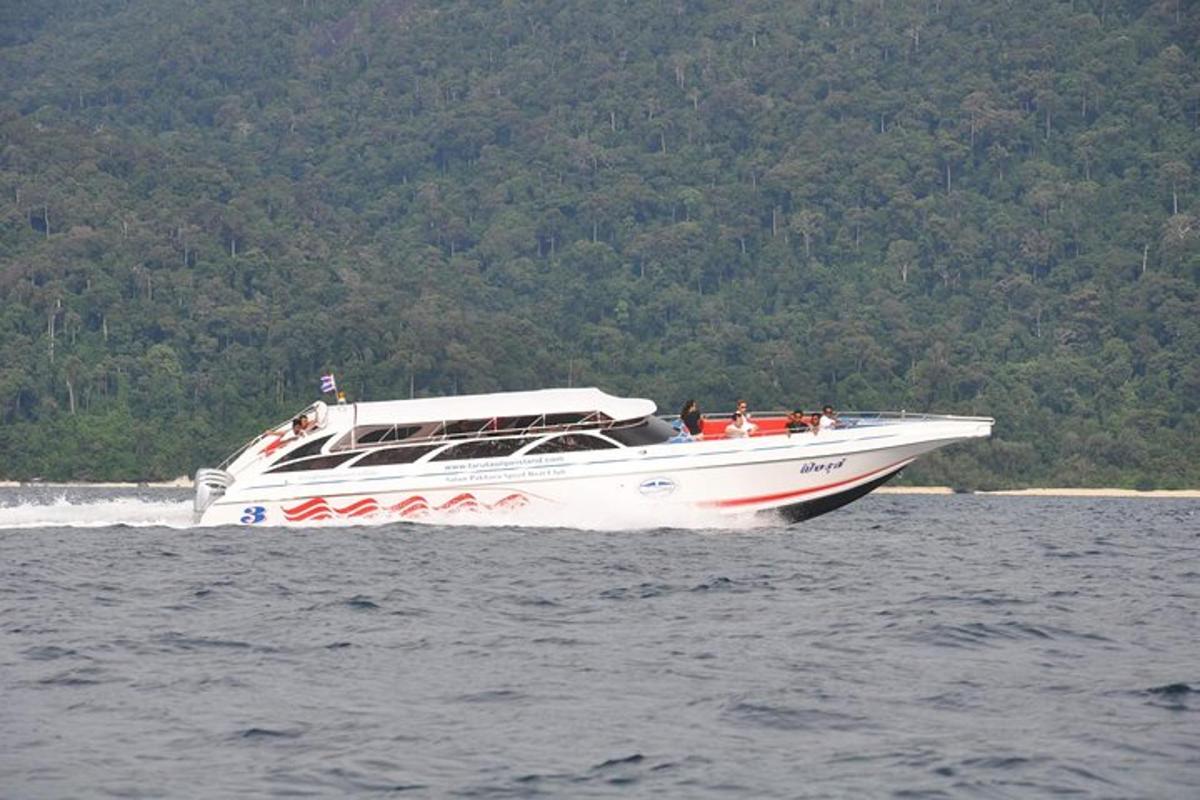 a white boat in the water with people on it
