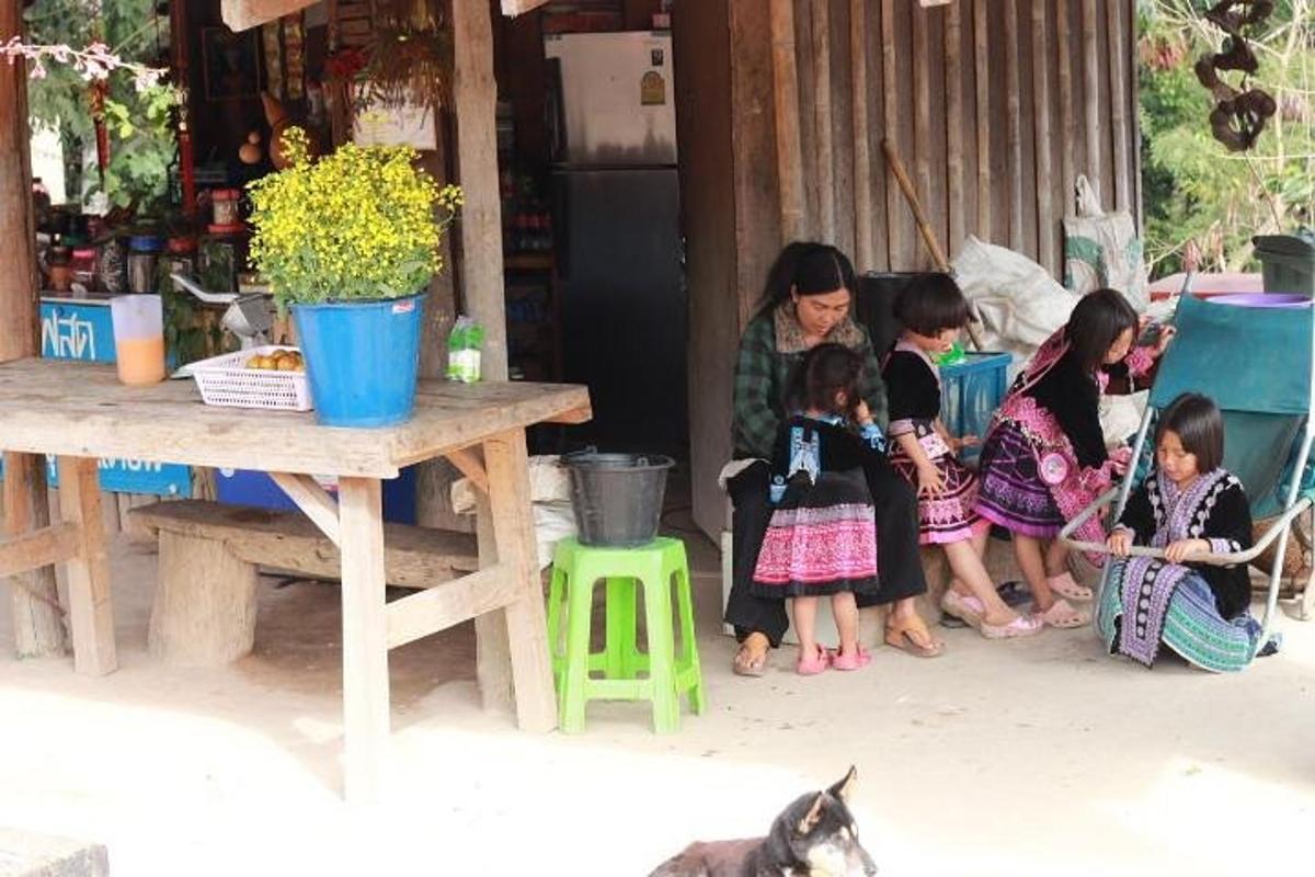 a group of children sitting next to a woman