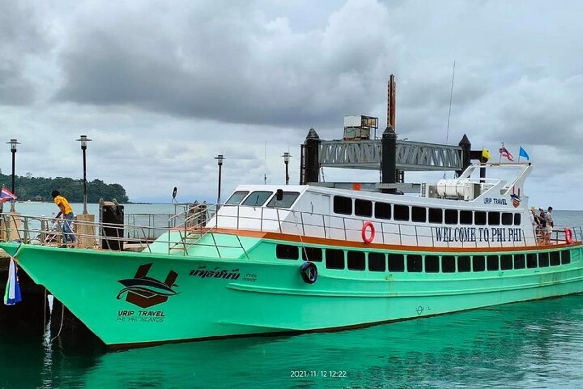 a green and white boat in the water