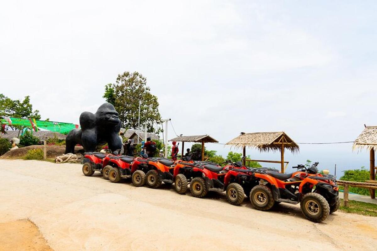 a row of atvs parked next to a statue