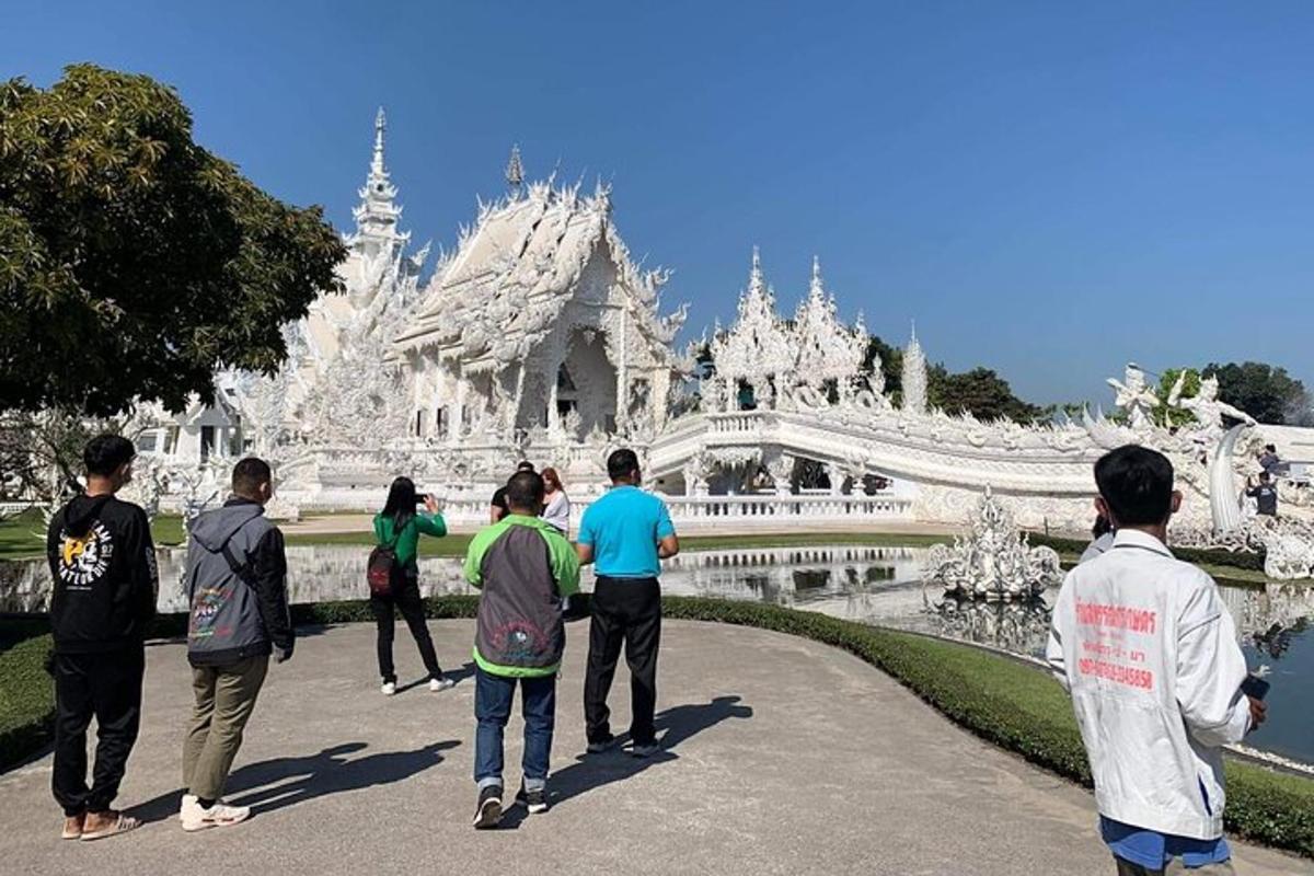 a group of people standing in front of a white temple