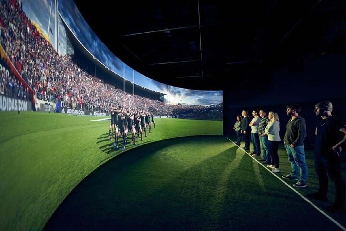 a group of people standing in front of a stadium