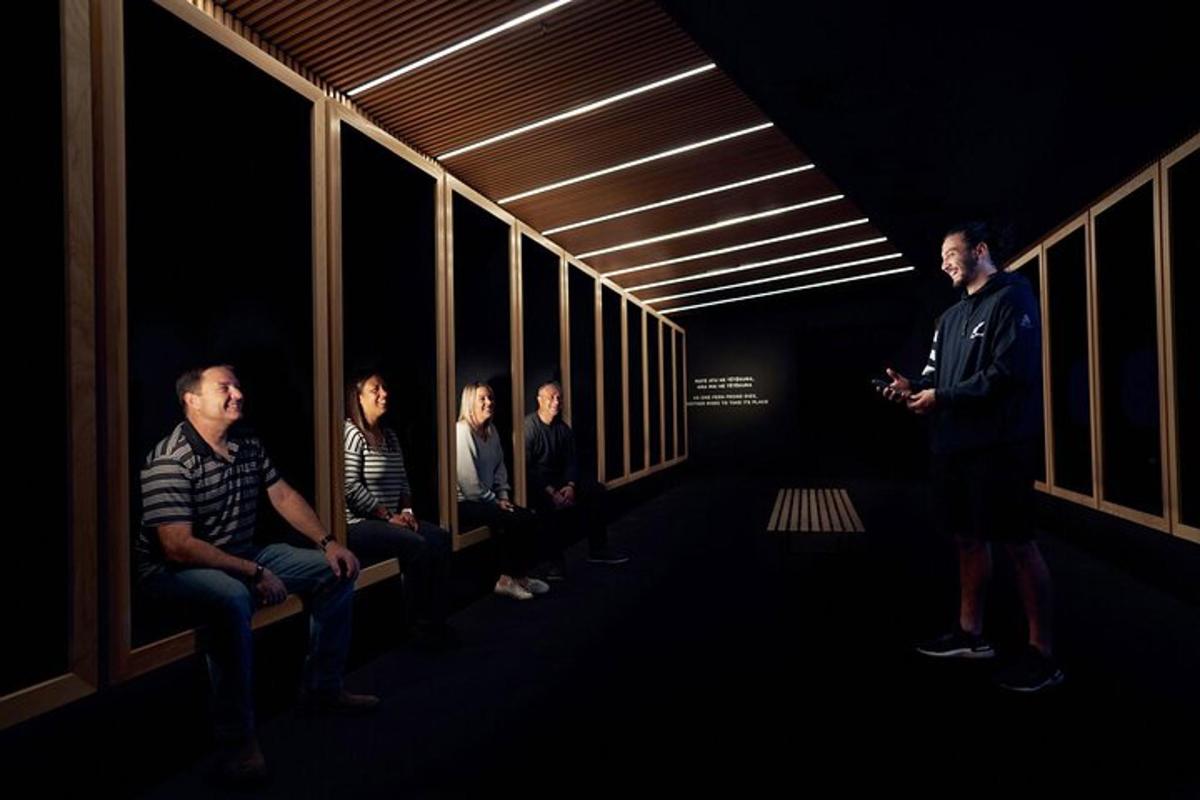 a man standing in a dark room with a group of people