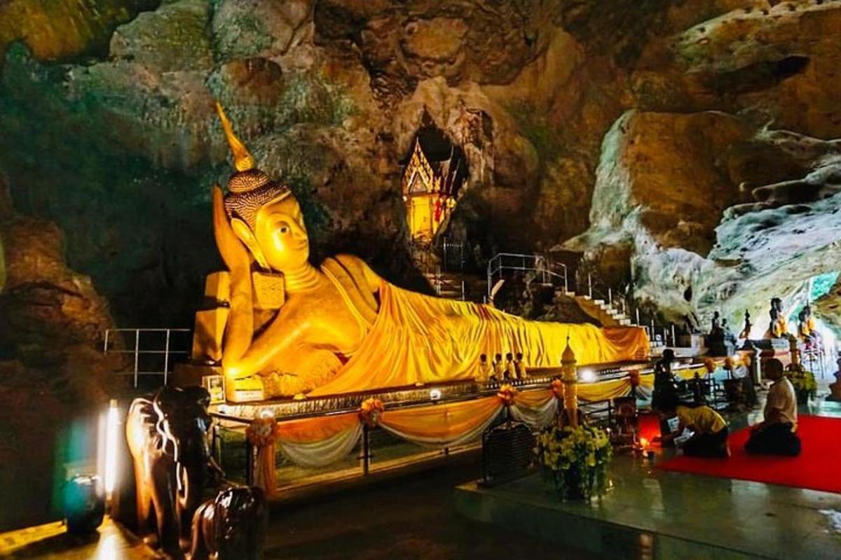 a large statue of a woman in a cave