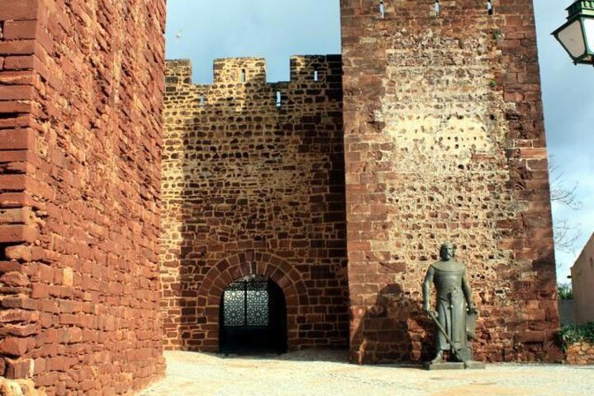 a brick building with a statue in front of it