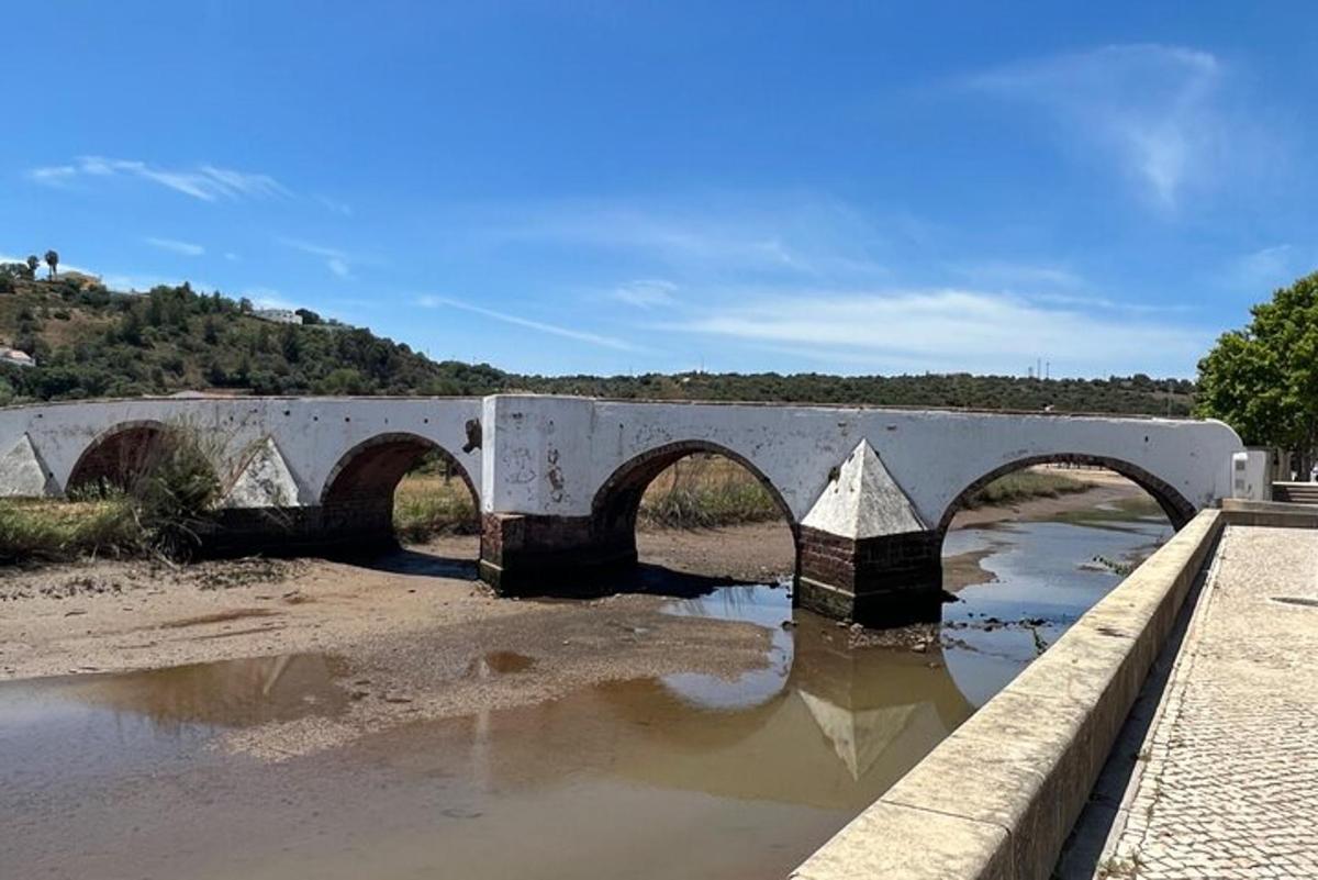a bridge with three arches over a river