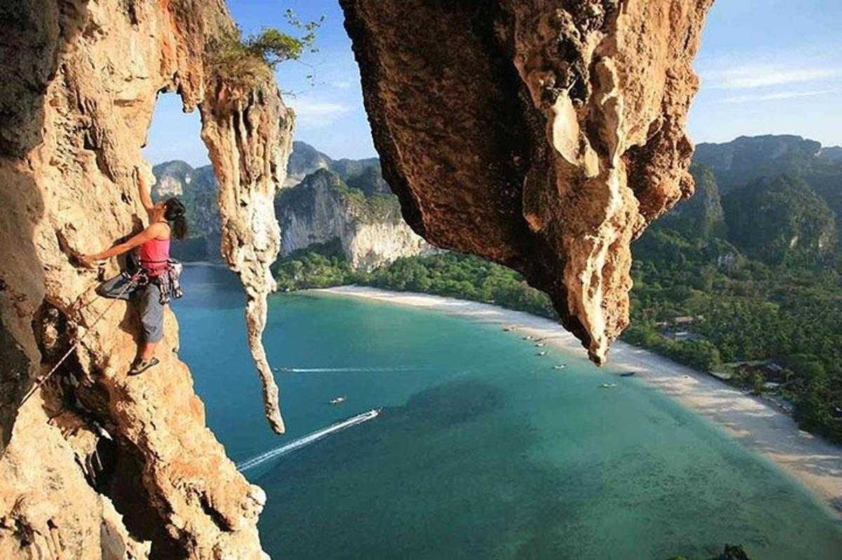 a person on a cliff looking down at a body of water