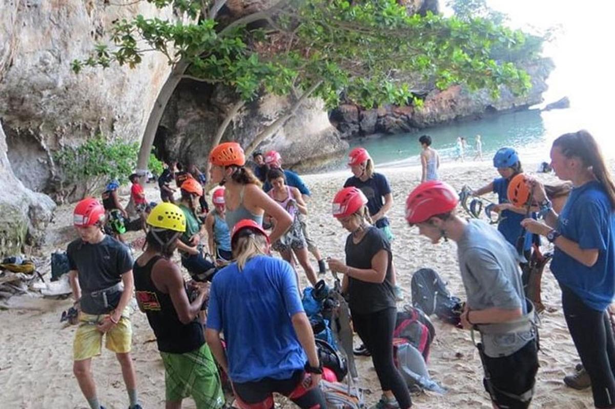 a group of people in helmets standing on a beach