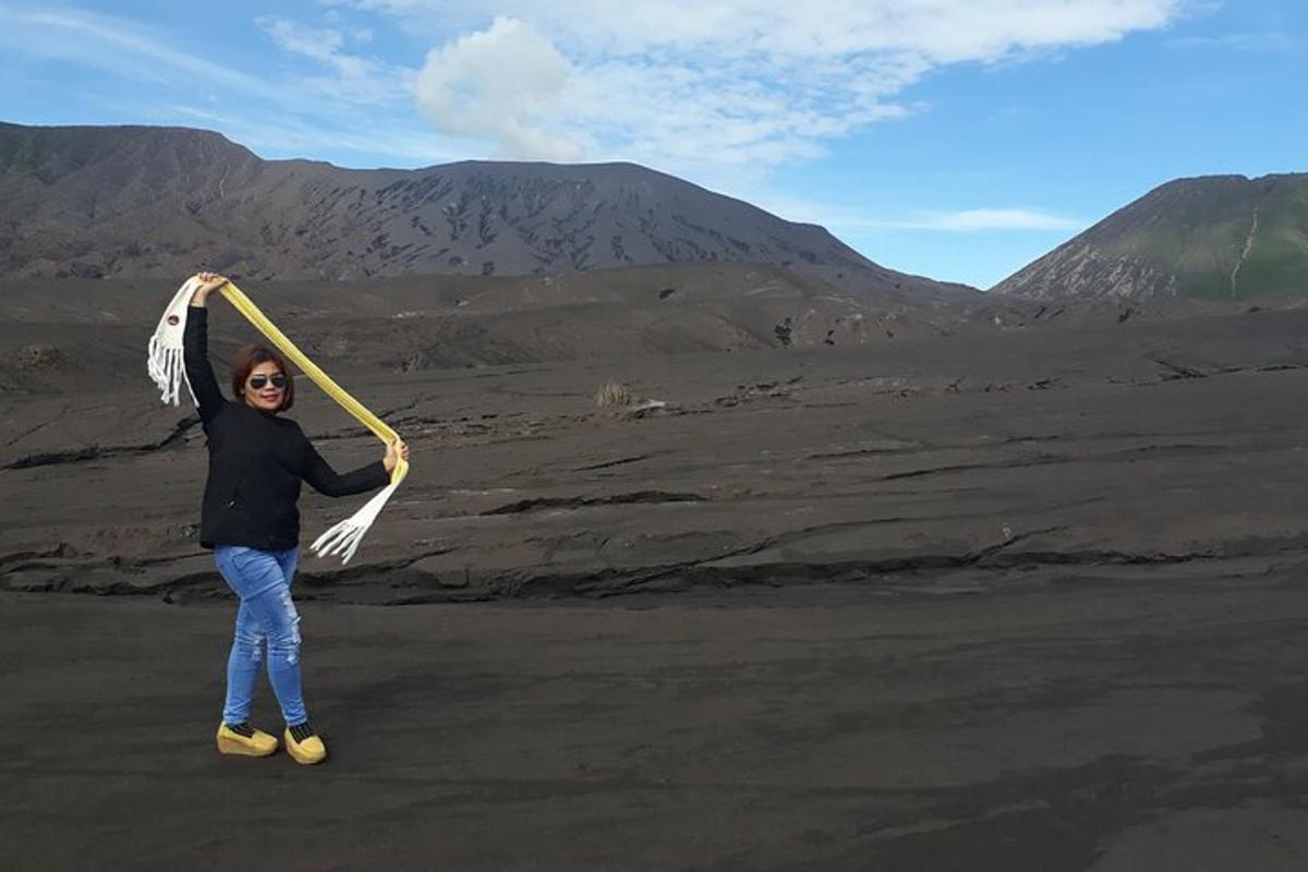 a woman is holding a stick in the desert