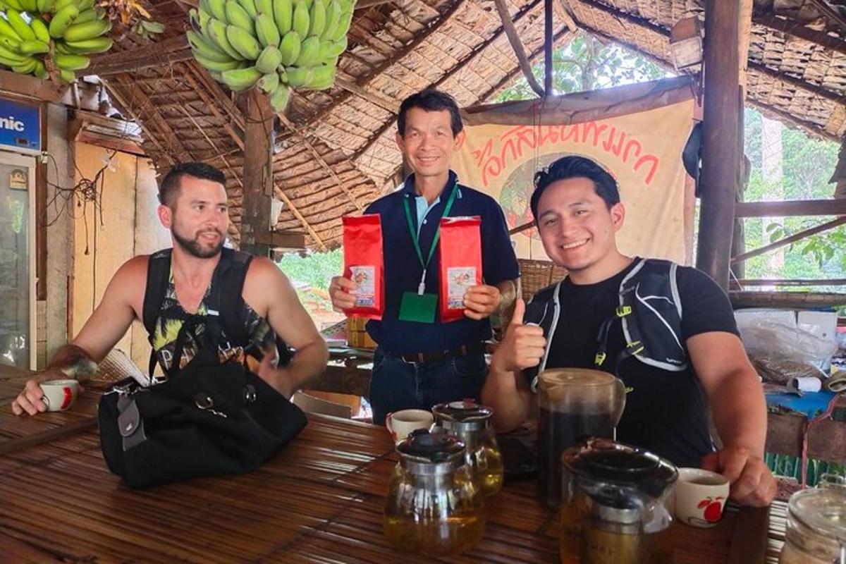 three men standing in front of a table with bananas