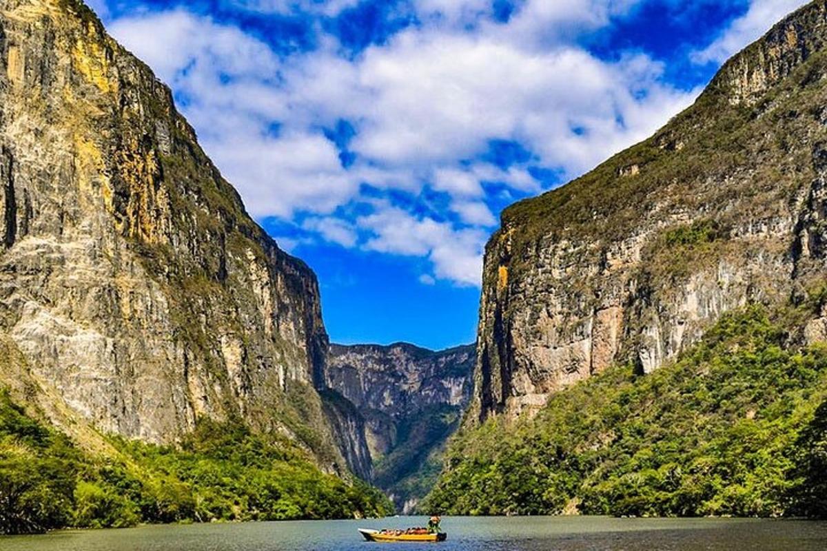 a boat in the water between two mountains
